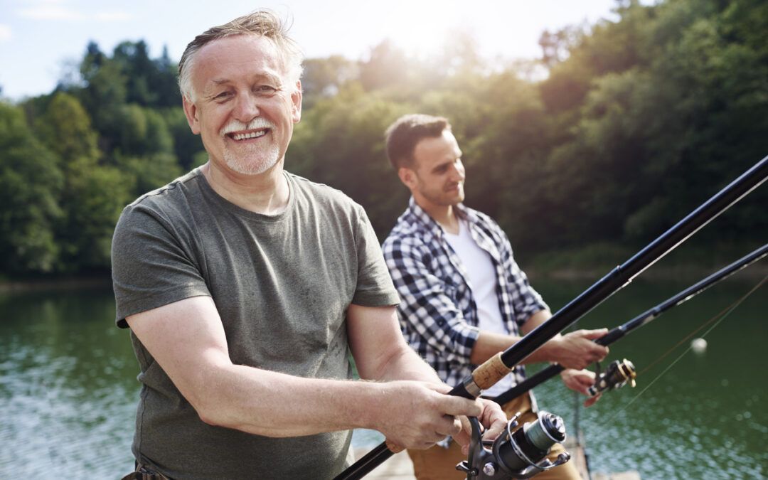 Portrait of cheerful senior man fishing